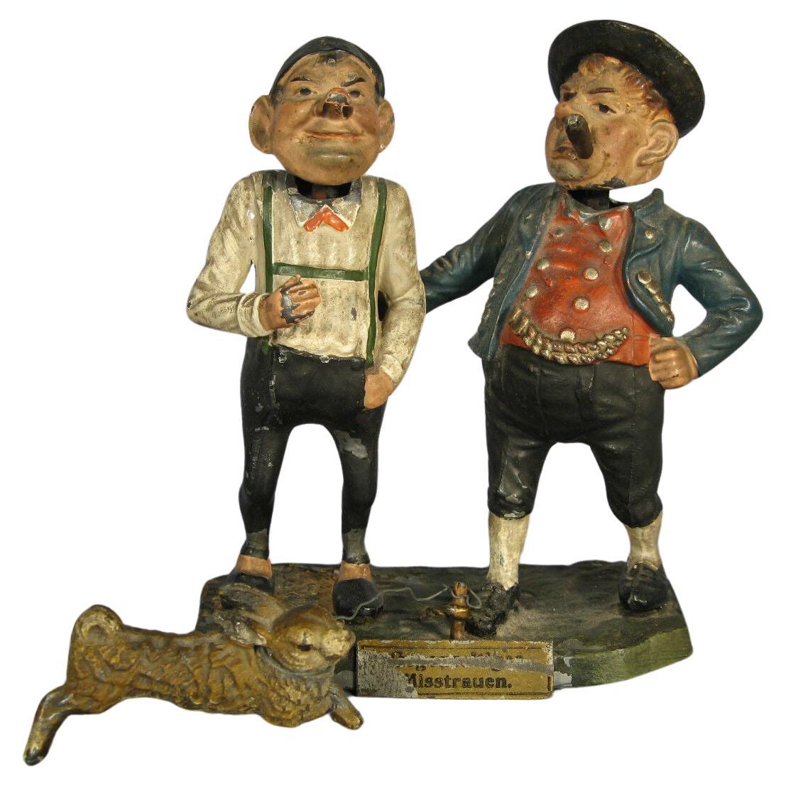 Early 20th-century German metal sculpture with animated oscillating heads.
