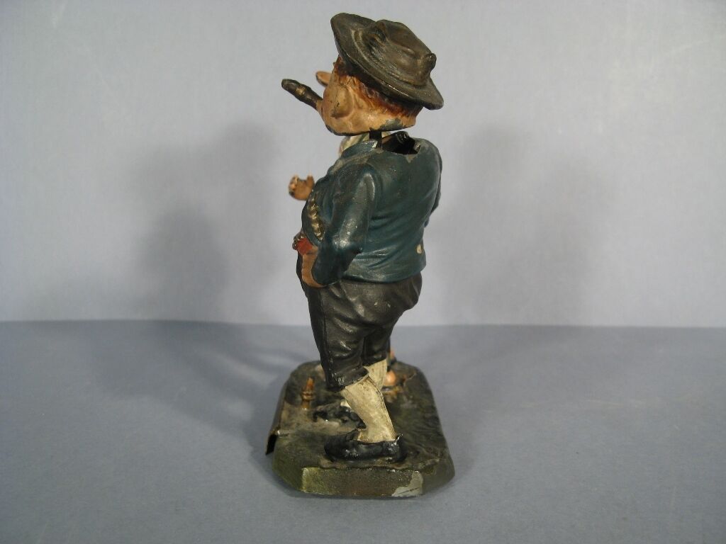 Humorous caricature figurine in traditional German attire.
