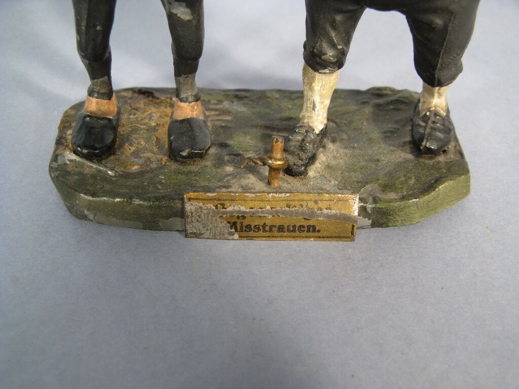 Antique German animated sculpture with titled base.
