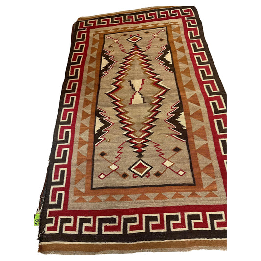 Rare antique Navajo wool rug featuring geometric patterns and earthy tones.
