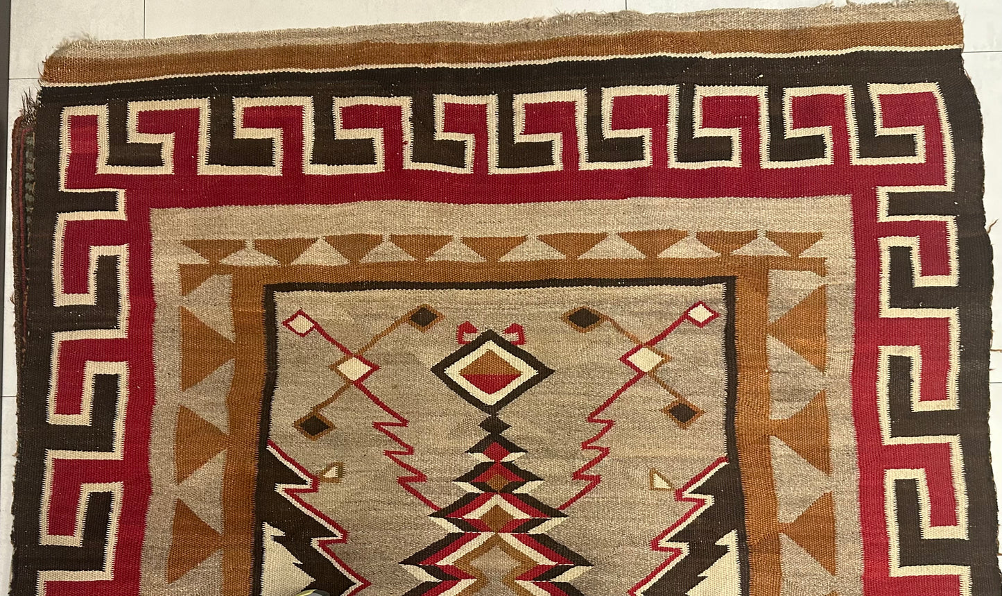 Intricate zigzag and diamond designs in 1880s Navajo rug.
