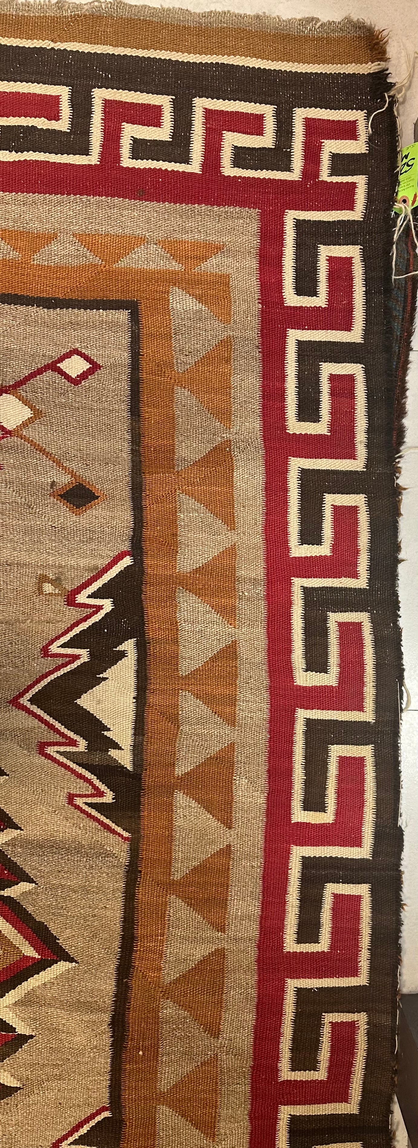 1880s rectangular Navajo wool rug with rich historical details.
