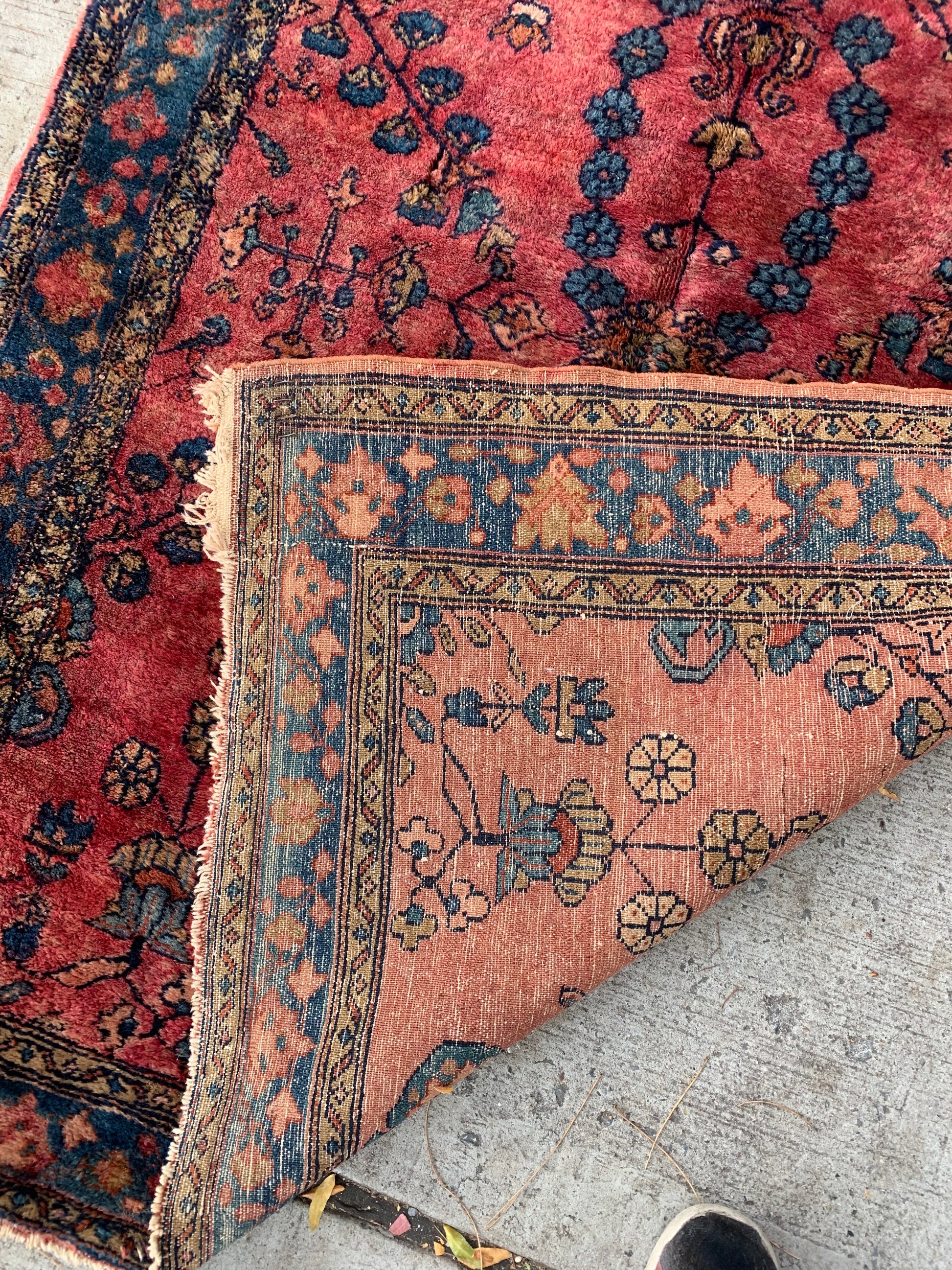 Persian wool rug showcasing 1920s craftsmanship.
