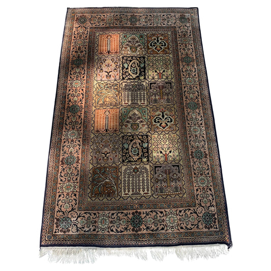 Handmade Persian Qum silk rug from the 1960s with intricate floral designs.
