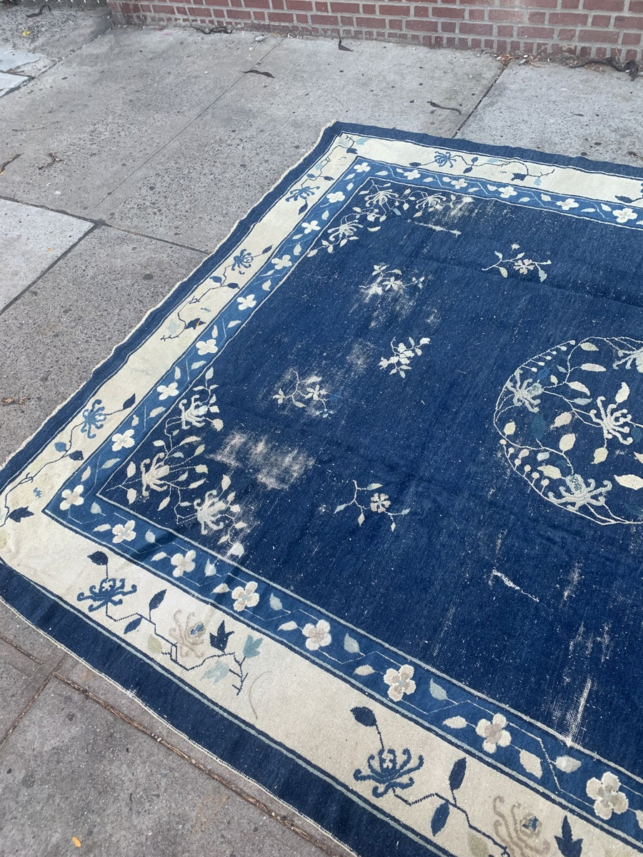 Handmade navy blue wool Peking rug with decorative borders.
