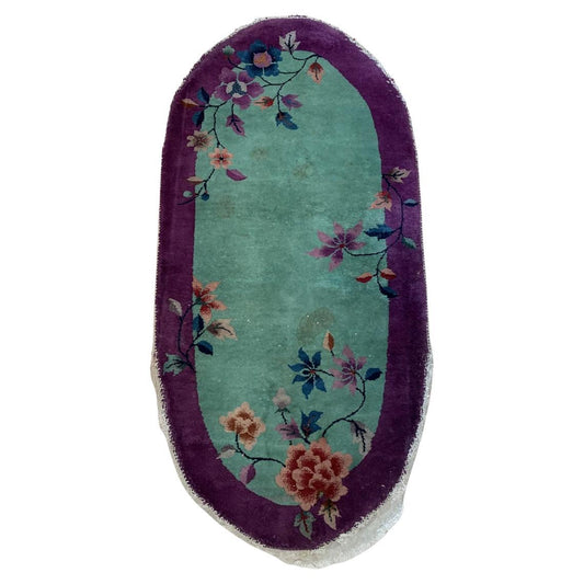 Antique Chinese Art Deco oval rug with vibrant floral design.
