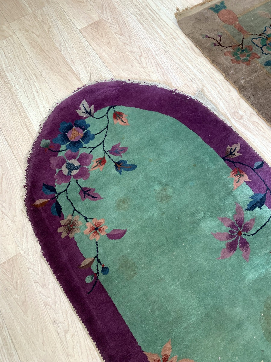 Handmade 1920s wool rug featuring blooming roses and peonies.
