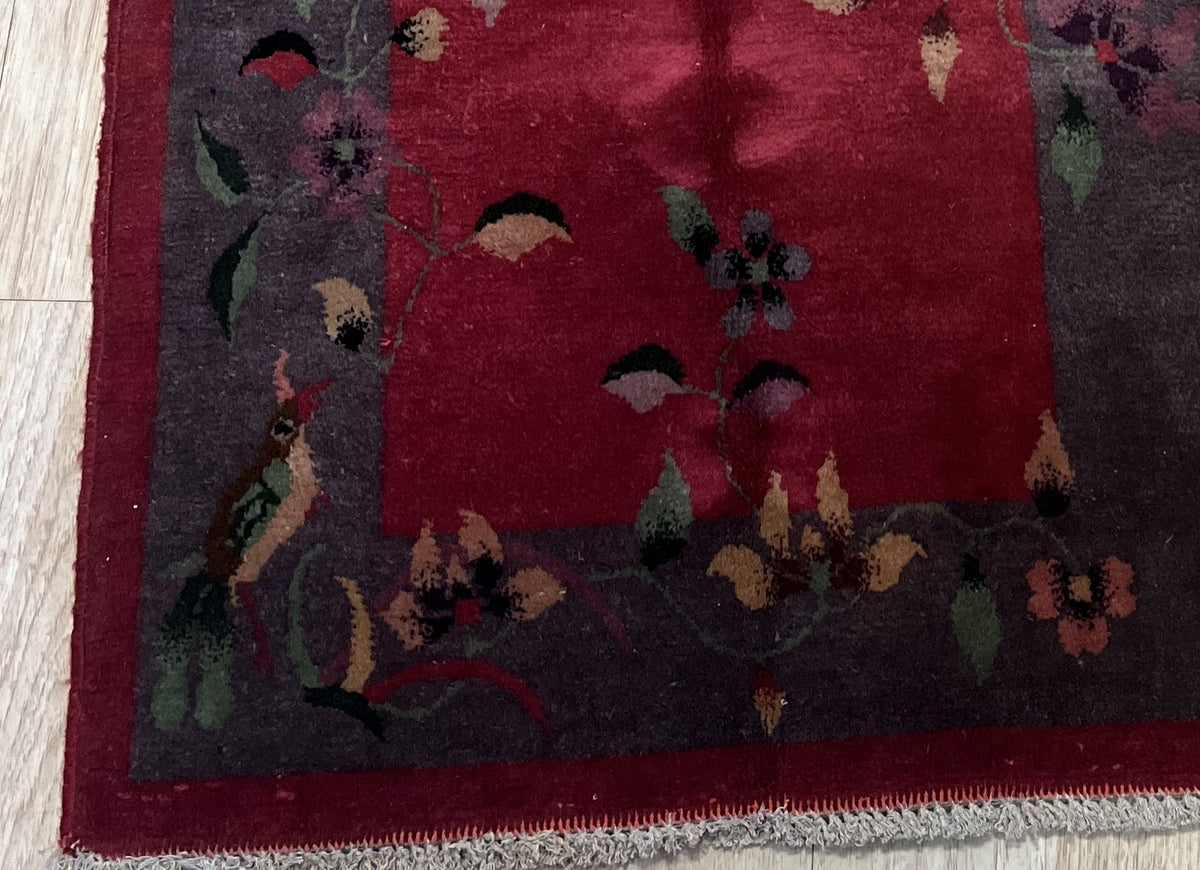 Rich red center and deep brown border of the handwoven Chinese carpet
