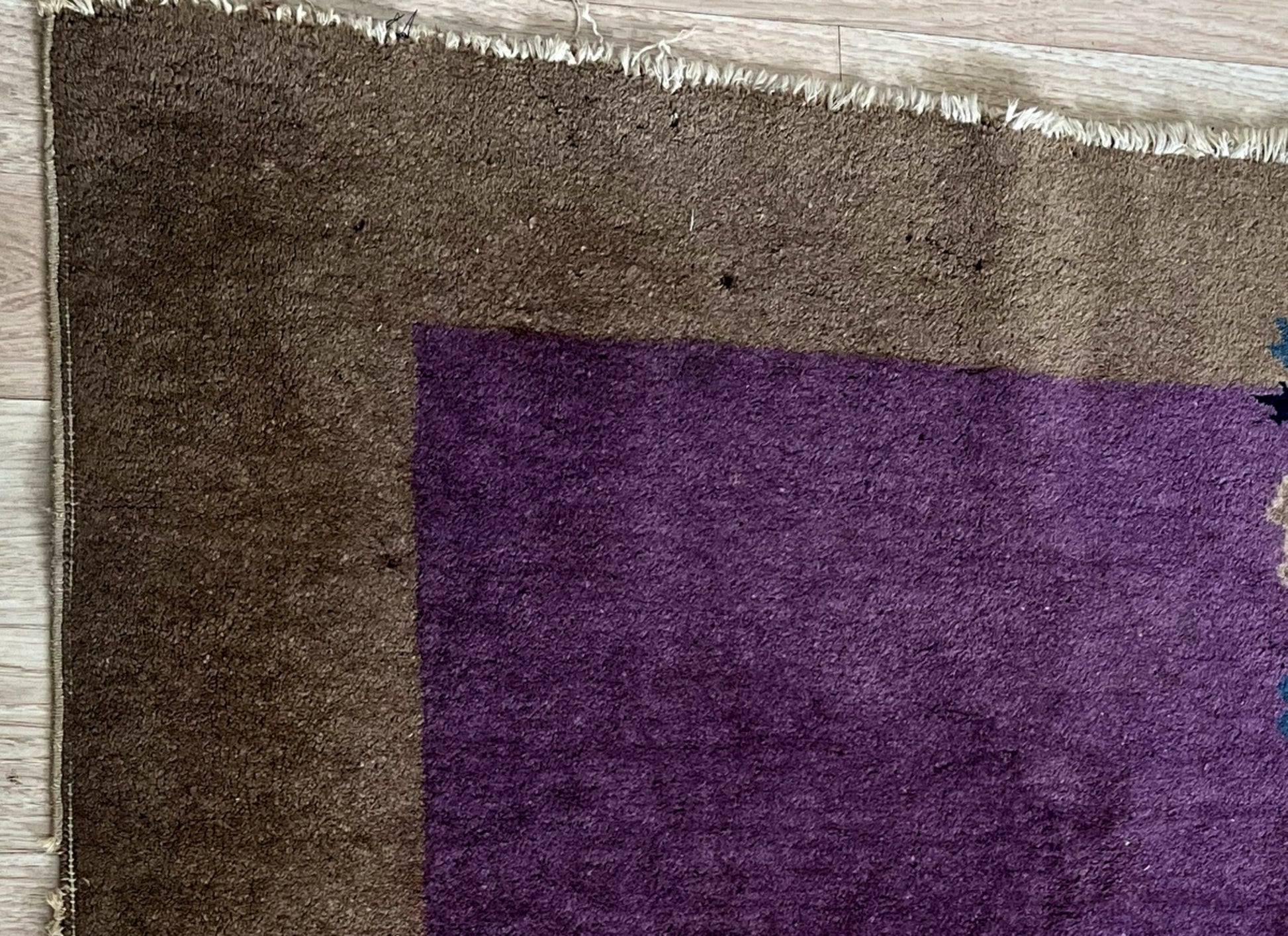 Elegant contrast of bold purple and warm brown in the rug’s design
