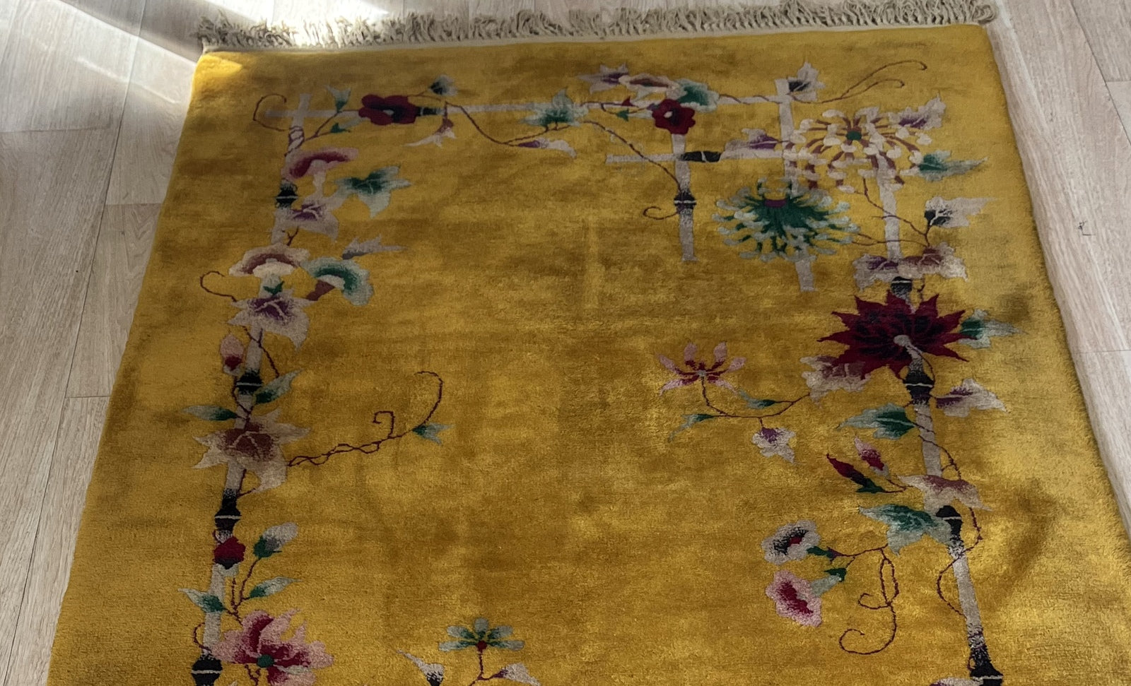 Close-up of floral design on antique Chinese wool rug
