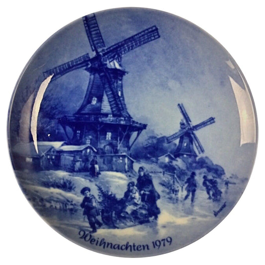 Vintage porcelain Christmas plate from 1979 featuring a winter village scene
