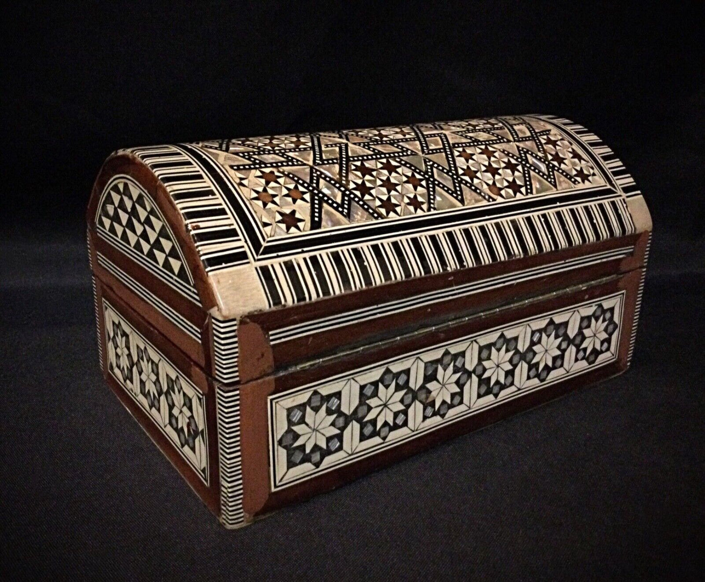 Detailed shot of the antique wood craftsmanship on the Syrian jewelry box.
