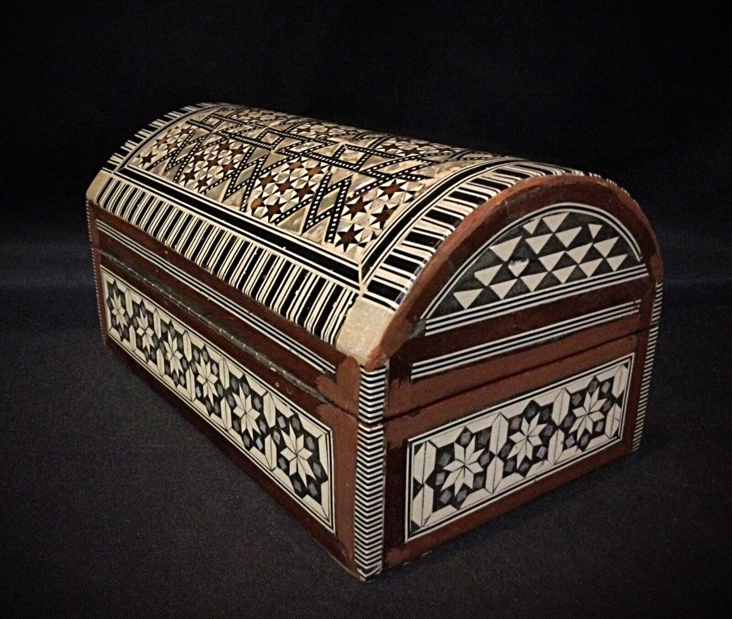 Interior view of the antique jewelry box with red velvet lining.
