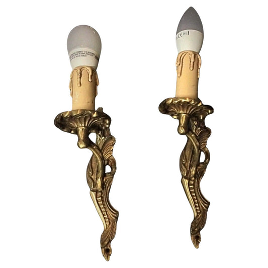 Pair of vintage brass wall sconces with classic ornate design
