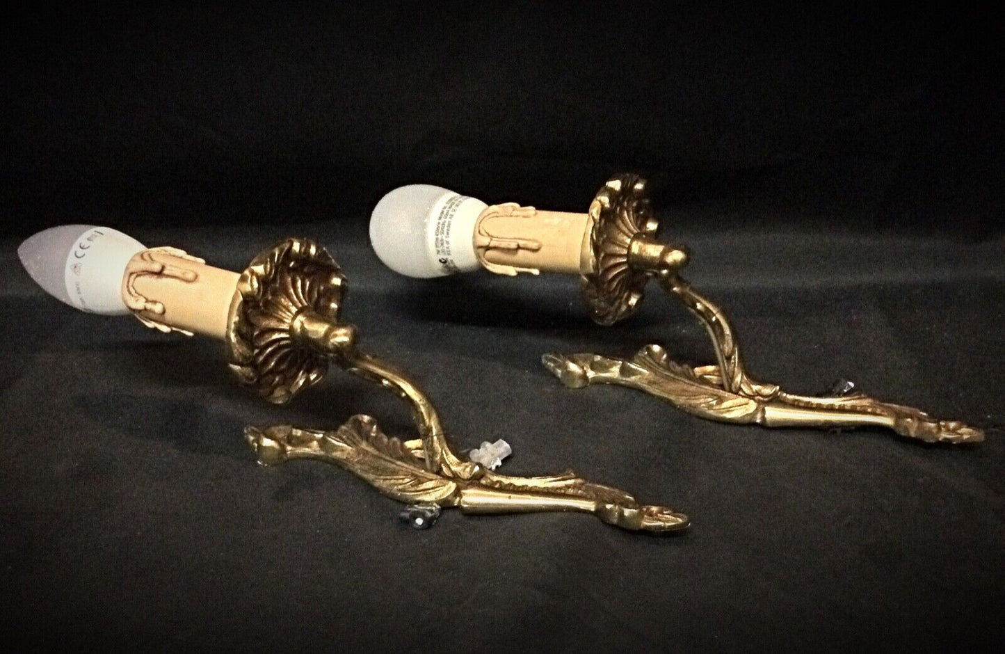 Close-up of intricate detailing on vintage brass wall sconces
