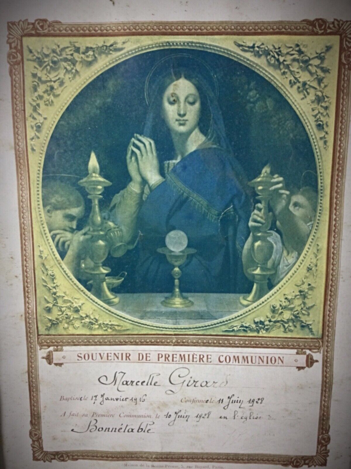 Close-up of Marcelle Girard’s First Communion photo with gilded frame
