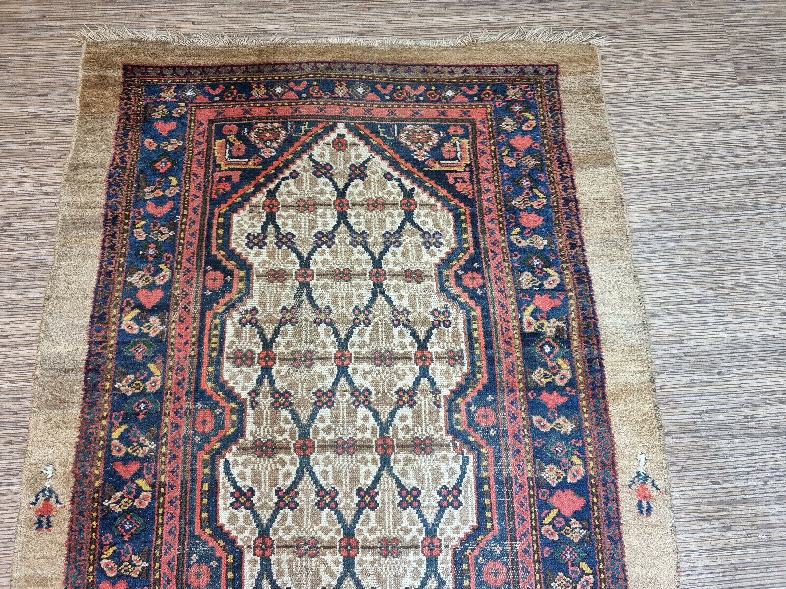 Close-up of striking contrast on Handmade Antique Persian Camel Hair Runner Rug - Detailed view showcasing the striking contrast between the cream-colored background and the deep red geometric shapes.