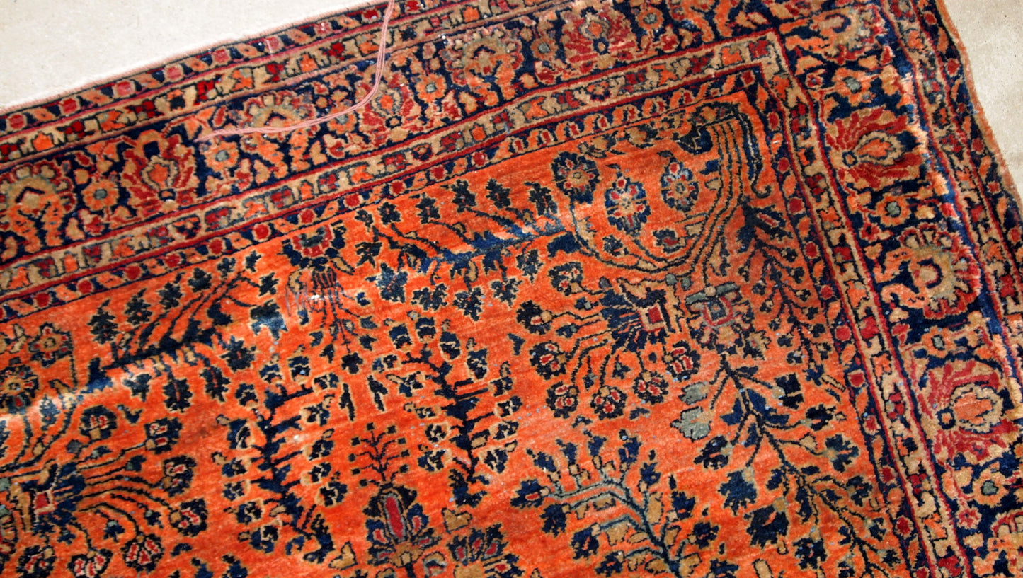 Antique handmade Persian Sarouk rug in original good condition. The rug is from the beginning of 20th century made in red wool.