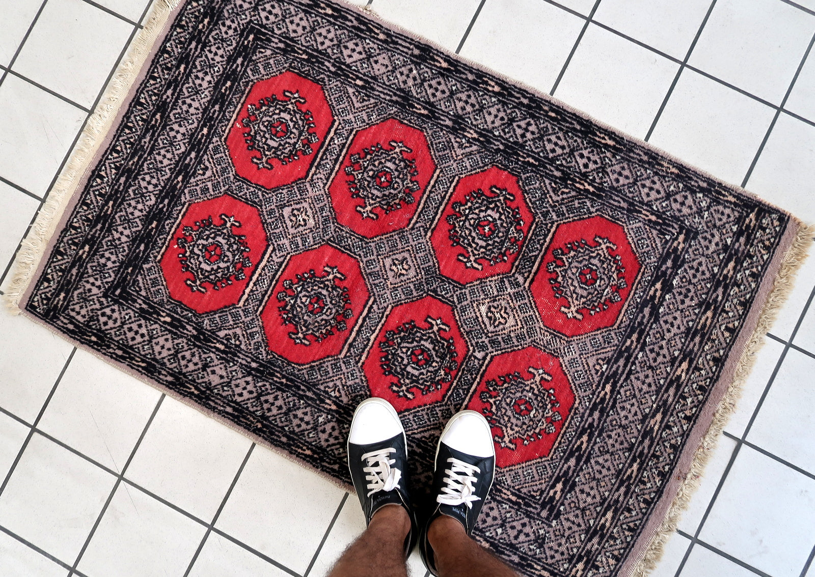 Handmade vintage Uzbek Bukhara rug in traditional design and red color. The rug is from the end of 20th century in original condition, it has some low pile.