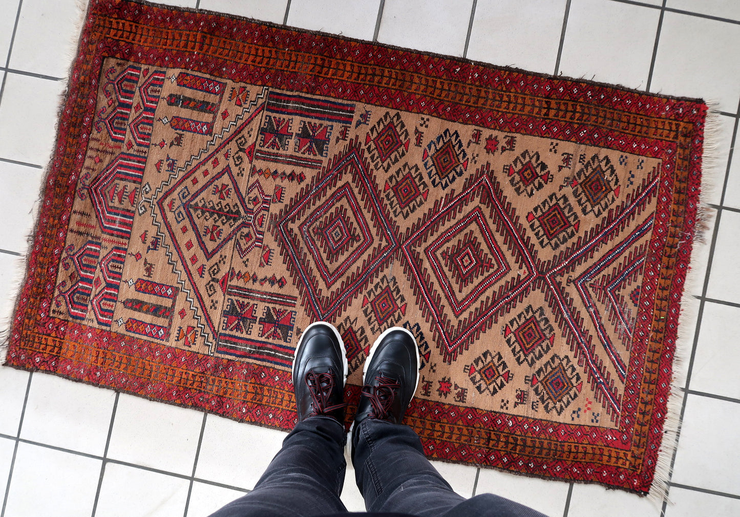 Handmade antique Afghan Baluch rug in tribal prayer design. The rug is from the beginning of 20th century in original condition, it has some low pile.