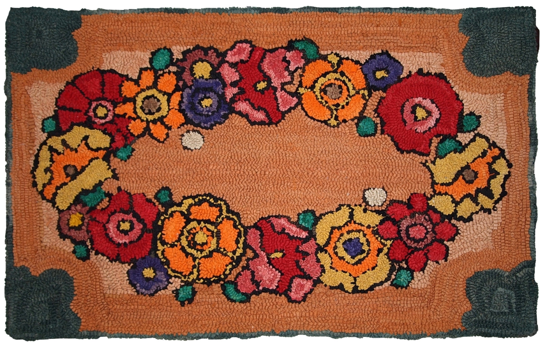 Close-up of the colorful flower center of the vintage hooked rug