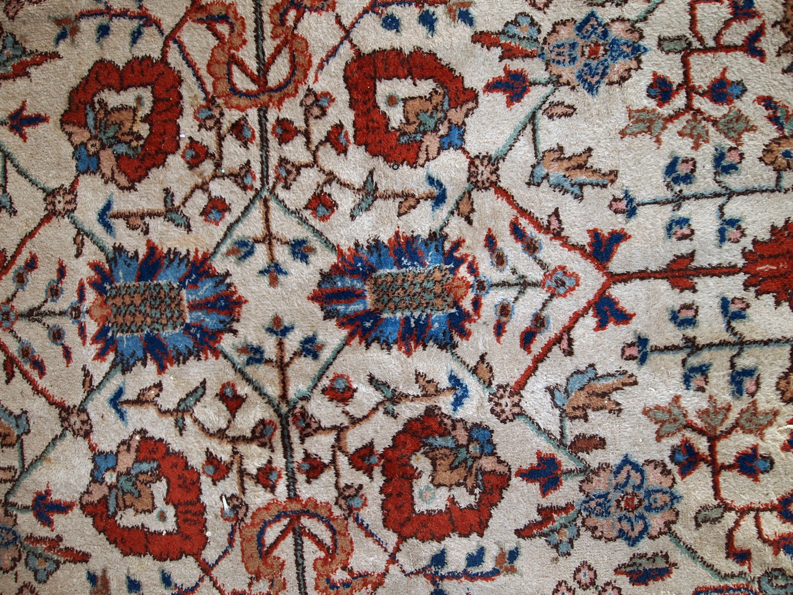 Handmade vintage Persian Mashad rug in beige shades and original good condition. Beautiful all-over design with garden accent is in blue and red colors.