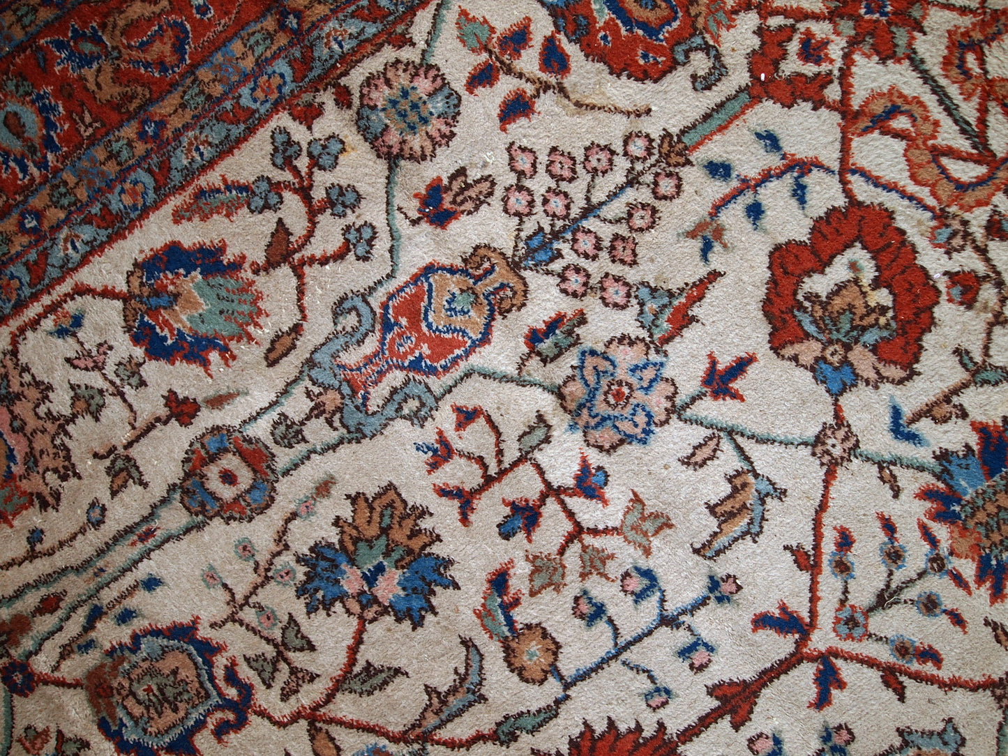 Handmade vintage Persian Mashad rug in beige shades and original good condition. Beautiful all-over design with garden accent is in blue and red colors.