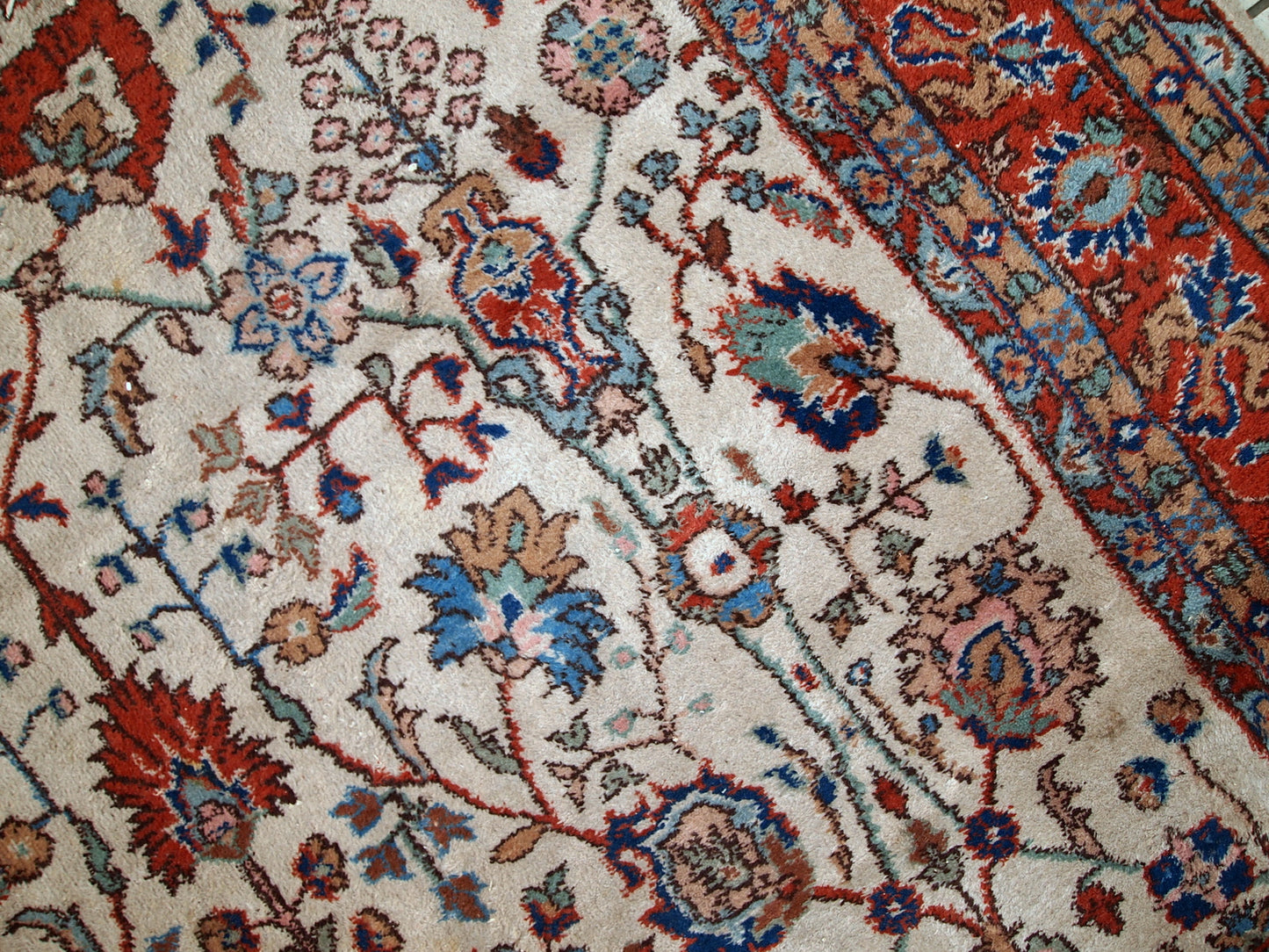 Handmade vintage Persian Mashad rug in beige shades and original good condition. Beautiful all-over design with garden accent is in blue and red colors.