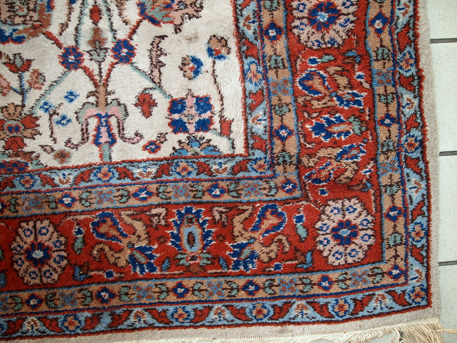 Handmade vintage Persian Mashad rug in beige shades and original good condition. Beautiful all-over design with garden accent is in blue and red colors.