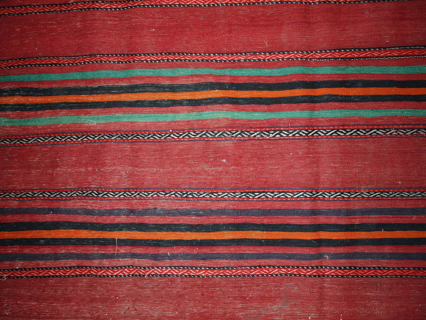 Handmade vintage Persian kilim in red shade with stripes. This kilim is in original condition, has some signs of age.