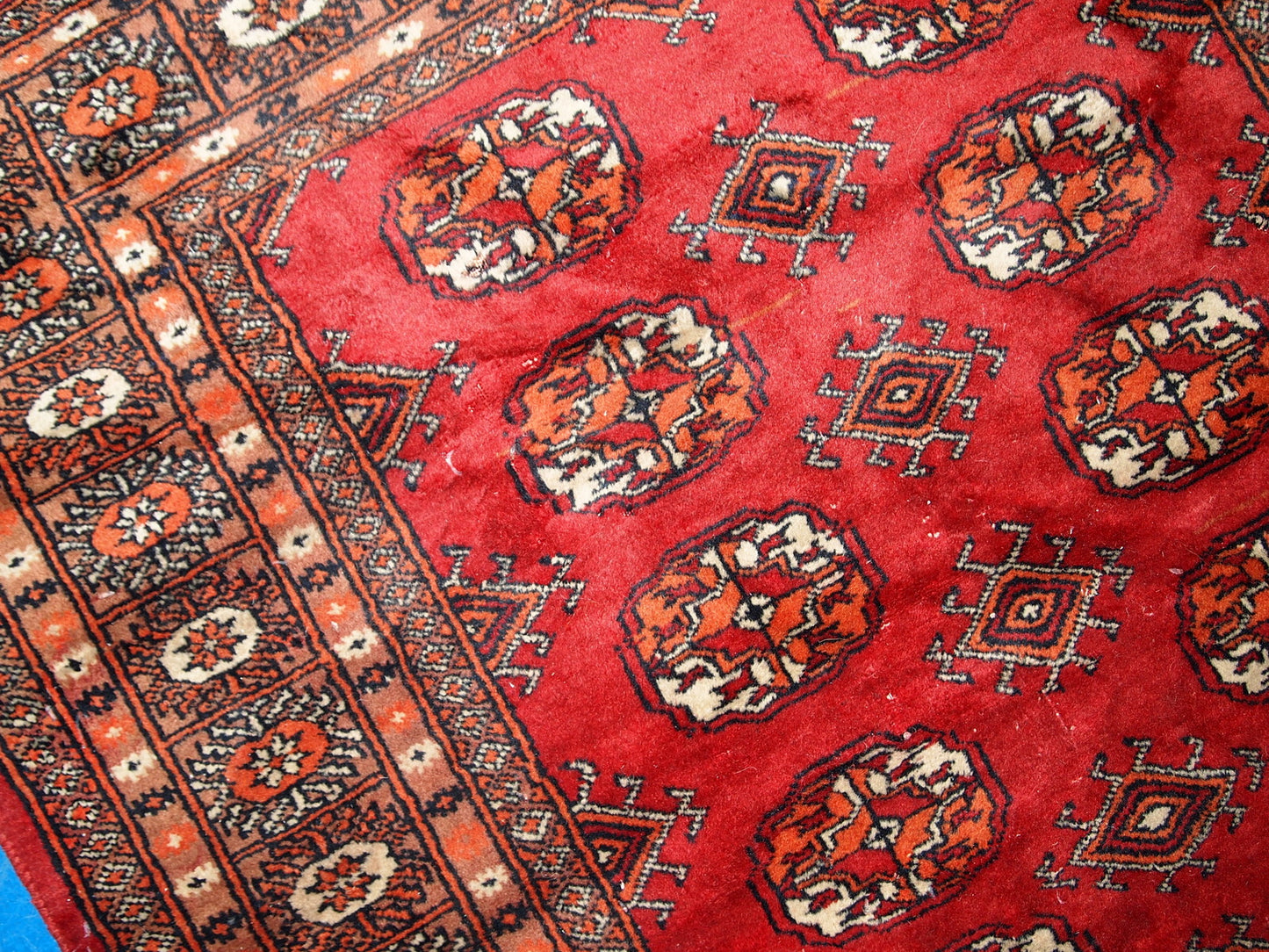 Vintage handmade Central Asian rug from Uzbekistan. The rug is in original good condition from the end of 20th century, it has minimal signs of age. It has been made from red wool and in classic Bukhara design.