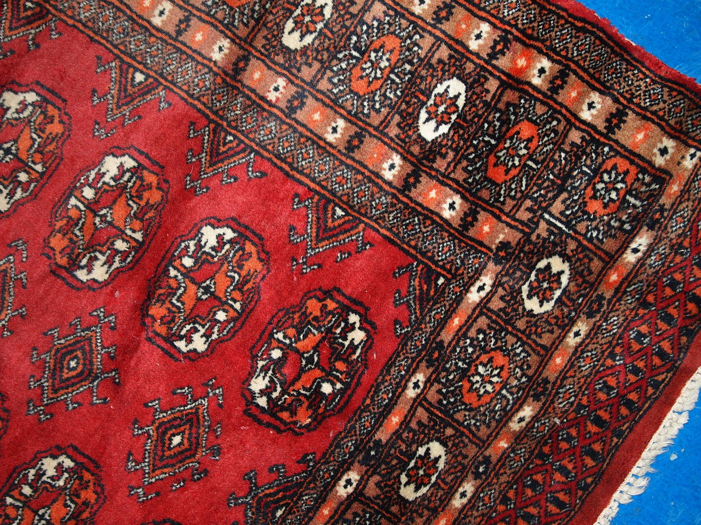 Vintage handmade Central Asian rug from Uzbekistan. The rug is in original good condition from the end of 20th century, it has minimal signs of age. It has been made from red wool and in classic Bukhara design.