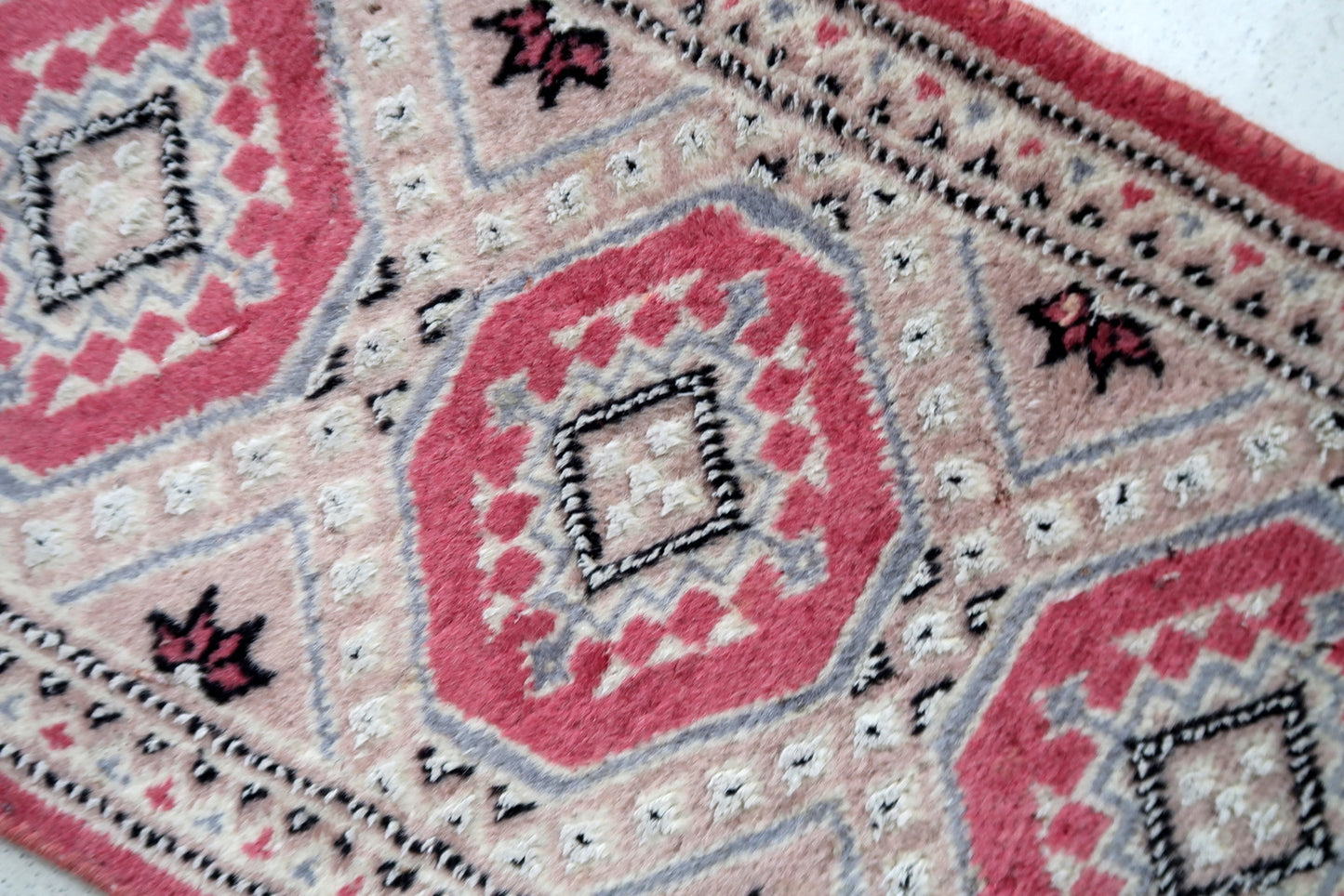 Vintage Uzbek Bukhara mat in light shades. The rug is from the end of 20th century made in wool with silk highlights. The rug is in original good condition.