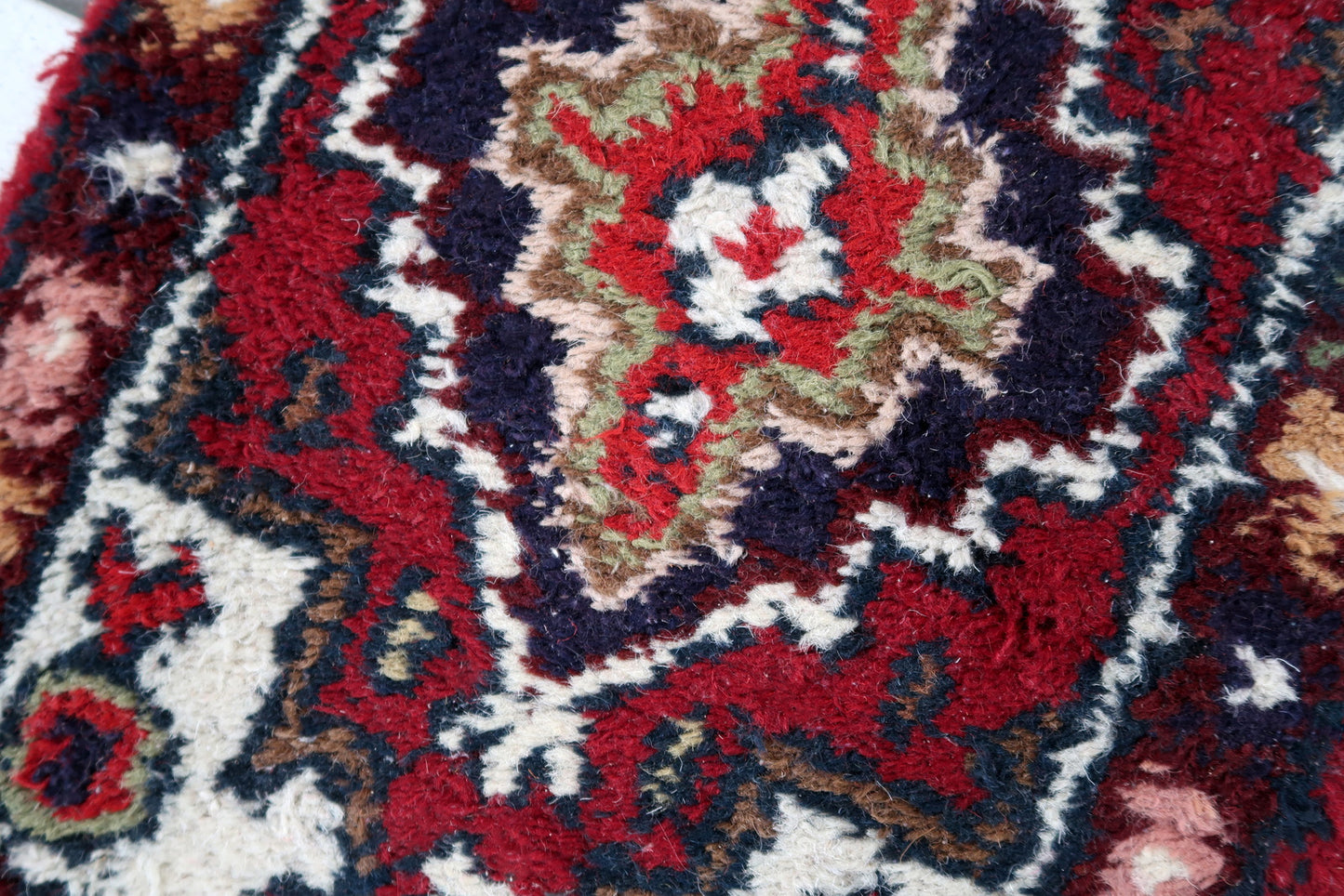 Handmade vintage Middle Eastern rug in traditional medallion design. The rug has been made in wool in the end of 20th century. It is in original good condition