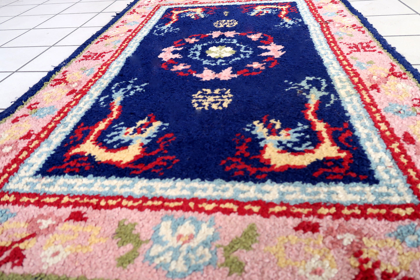 Vintage French Savonnerie rug in night blue and pink colors. The rug has been made in wool in the end of 20th century. It is in original good condition. The rug has dragon design.