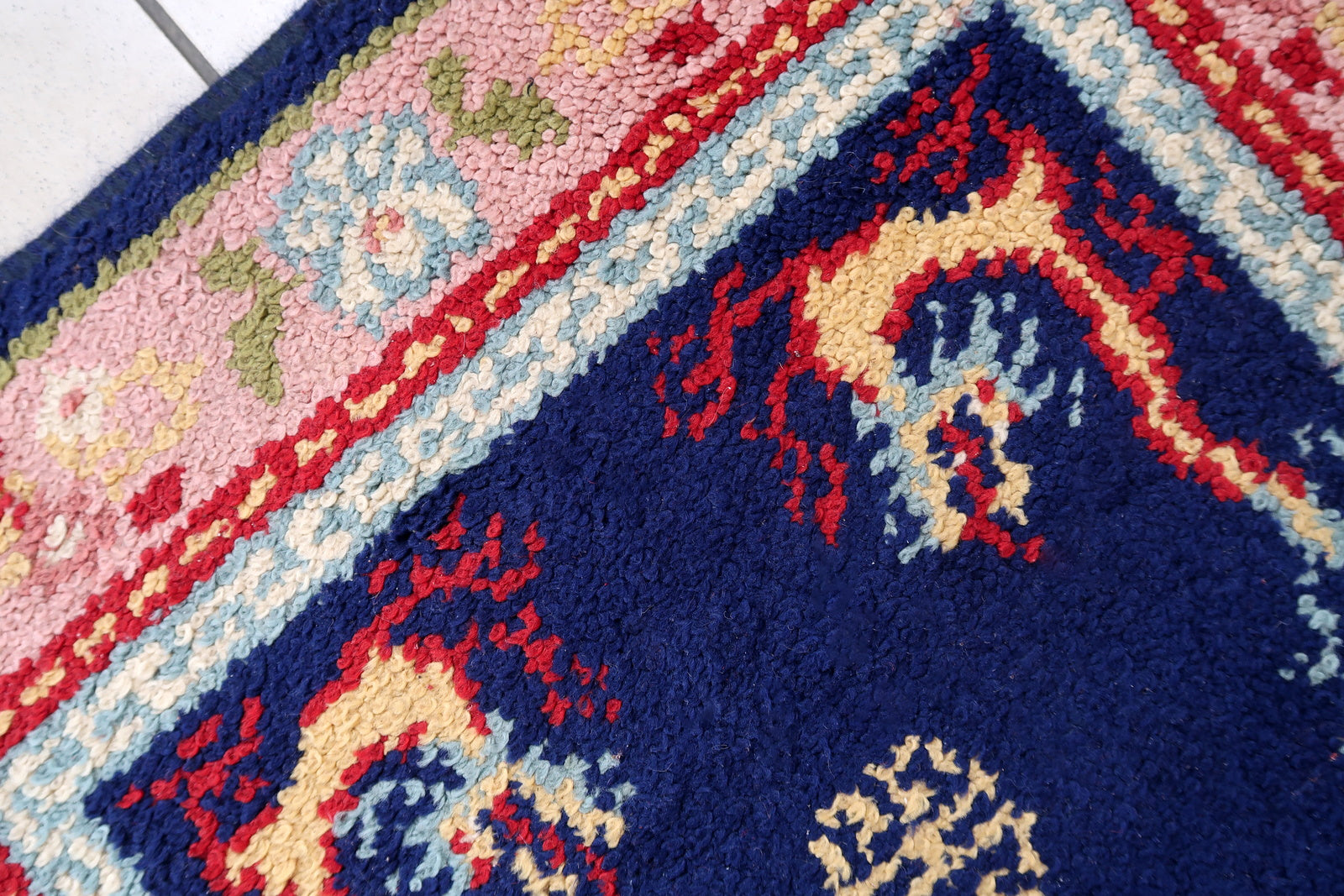 Vintage French Savonnerie rug in night blue and pink colors. The rug has been made in wool in the end of 20th century. It is in original good condition. The rug has dragon design.