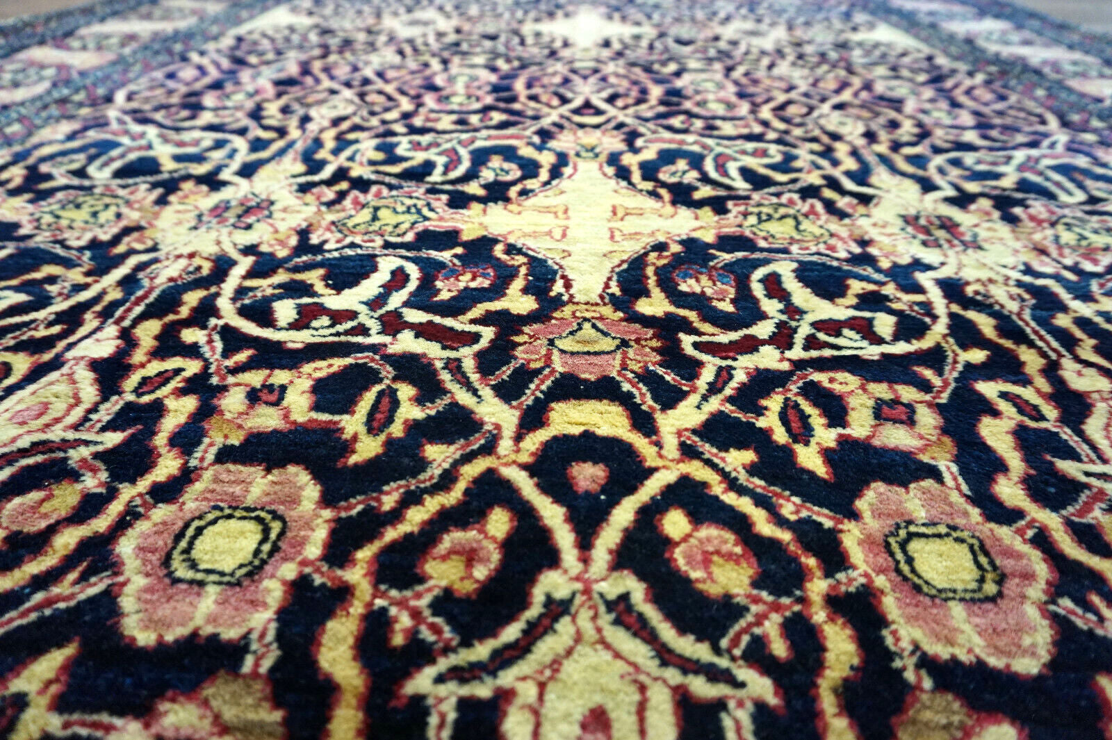 Handmade antique Persian Isfahan rug in unusual repeating design. The rug is from the beginning of 20th century in original good condition. It is made in wool.